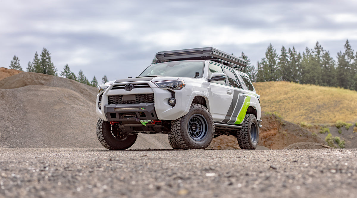 Built 5th Gen Toyota 4Runner on a gravel trail under a cloudy sky